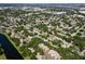Extensive aerial view showcasing a suburban area with mature trees, ponds and lakes at 11368 93Rd St, Largo, FL 33773