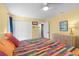 Inviting bedroom with colorful quilt, ceiling fan, and lots of natural light from the nearby doorway at 11368 93Rd St, Largo, FL 33773