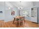 Bright dining room features modern chandelier, a glass table and wood floors at 11368 93Rd St, Largo, FL 33773