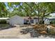 Charming single-story home with a spacious driveway and large trees providing ample shade at 11368 93Rd St, Largo, FL 33773