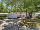 Charming single-story home with a well-manicured lawn, mature trees, and a two-car garage at 11368 93Rd St, Largo, FL 33773