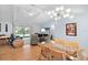 Bright and open living area with hardwood floors, modern lighting, and access to the outdoor space at 11368 93Rd St, Largo, FL 33773