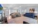 Open-concept living area featuring hardwood floors, vaulted ceilings, and modern lighting fixtures at 11368 93Rd St, Largo, FL 33773