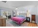 Main bedroom with sliding glass doors, ceiling fan and ensuite at 11368 93Rd St, Largo, FL 33773