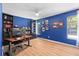 Office space with dark blue walls, laminate floors and natural light at 11368 93Rd St, Largo, FL 33773