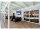Covered patio with tile floors, a ceiling fan, and a large glass sliding door providing backyard pool views at 11368 93Rd St, Largo, FL 33773