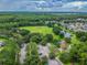 Aerial view of community featuring green spaces, playground, pond, and residential areas at 12525 Sparkleberry Rd, Tampa, FL 33626