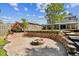 Backyard featuring a fire pit, tiered landscaping, and a view of the two-story home and deck at 12525 Sparkleberry Rd, Tampa, FL 33626