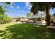 Spacious backyard featuring a patio, pond, and fire pit area, perfect for outdoor living and entertaining at 12525 Sparkleberry Rd, Tampa, FL 33626