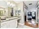 Bathroom with granite counters, double sinks, and a door leading to the main bedroom at 12525 Sparkleberry Rd, Tampa, FL 33626