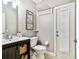 Charming bathroom features a vanity with sink, toilet, and a door with built-in blinds at 12525 Sparkleberry Rd, Tampa, FL 33626