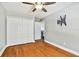 Empty bedroom featuring hardwood floors, a ceiling fan, and closet at 12525 Sparkleberry Rd, Tampa, FL 33626