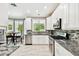 Modern kitchen boasts stainless steel appliances, granite countertops, tile backsplash, and ample cabinet space at 12525 Sparkleberry Rd, Tampa, FL 33626