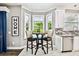 Bright kitchen nook featuring a small table and chairs with natural light streaming through the windows at 12525 Sparkleberry Rd, Tampa, FL 33626