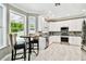 Bright kitchen with white cabinetry, stainless steel appliances, and a breakfast nook overlooking the backyard at 12525 Sparkleberry Rd, Tampa, FL 33626