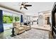 Open-concept living space flows into the kitchen and features a view of the pool through sliding glass doors at 12525 Sparkleberry Rd, Tampa, FL 33626