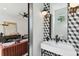 Chic half-bath with geometric patterned wall, modern fixtures, and elegant design elements at 1312 W Azeele St # 2, Tampa, FL 33606