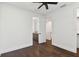 Spacious bedroom showing wood floors, fan, bathroom access, and staircase at 1312 W Azeele St # 2, Tampa, FL 33606