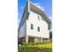 Modern home showcasing its architectural design, elevated structure, and well-landscaped surroundings at 1312 W Azeele St # 2, Tampa, FL 33606