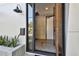 Stylish front door with glass pane, black hardware, and neutral colored concrete block at 1312 W Azeele St # 2, Tampa, FL 33606