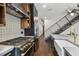Gourmet kitchen with stainless steel appliances, custom cabinets, designer backsplash, and hardwood floors at 1312 W Azeele St # 2, Tampa, FL 33606