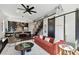 Open-concept living room showcasing modern furniture, elegant decor, and seamless flow to the kitchen and staircase at 1312 W Azeele St # 2, Tampa, FL 33606