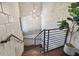 Wooden staircase with concrete block wall and modern chandelier at 1312 W Azeele St # 2, Tampa, FL 33606