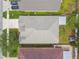 Aerial view of a well-maintained home, highlighting the roof and surrounding landscaping at 1318 Crimson Clover Ln, Wesley Chapel, FL 33543