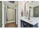 This bathroom features a tiled backsplash, matte black faucet, and tile floors at 1318 Crimson Clover Ln, Wesley Chapel, FL 33543
