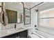 The renovated bathroom features a subway tiled shower and vanity with matte black hardware at 1318 Crimson Clover Ln, Wesley Chapel, FL 33543