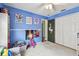 This bedroom features carpet flooring, and wall decorations at 1318 Crimson Clover Ln, Wesley Chapel, FL 33543