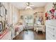 This bedroom features a full size bed, ceiling fan and natural light from the window at 1318 Crimson Clover Ln, Wesley Chapel, FL 33543