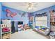 This bedroom features butterfly wall decorations, a ceiling fan, carpet flooring, and a armchair at 1318 Crimson Clover Ln, Wesley Chapel, FL 33543