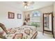 This bedroom features a queen sized bed, a window and a floor length mirror at 1318 Crimson Clover Ln, Wesley Chapel, FL 33543