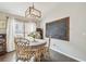 Charming dining room with hardwood floors, chandelier, and adjacent chalkboard wall at 1318 Crimson Clover Ln, Wesley Chapel, FL 33543