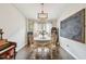 Comfortable dining area with chandelier and chalkboard, perfect for Gathering meals at 1318 Crimson Clover Ln, Wesley Chapel, FL 33543