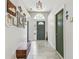 Bright entryway with a decorative bench and view of the front door at 1318 Crimson Clover Ln, Wesley Chapel, FL 33543