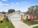 Charming single-story home featuring a well-manicured lawn and attached two-car garage at 1318 Crimson Clover Ln, Wesley Chapel, FL 33543