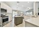 Bright kitchen features white cabinets, stainless steel appliances, and a center island at 1318 Crimson Clover Ln, Wesley Chapel, FL 33543