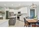 Bright kitchen featuring stainless steel appliances and center island adjacent to dining area at 1318 Crimson Clover Ln, Wesley Chapel, FL 33543