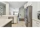Modern kitchen with stainless steel appliances and view to the dining room at 1318 Crimson Clover Ln, Wesley Chapel, FL 33543