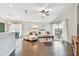 Bright living room featuring hardwood floors, vaulted ceiling, and access to the dining area at 1318 Crimson Clover Ln, Wesley Chapel, FL 33543