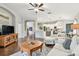 Spacious open-concept living room with wood floors and seamless transition to the kitchen at 1318 Crimson Clover Ln, Wesley Chapel, FL 33543