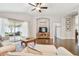 Spacious living room with hardwood floors and sliding door access to the screened in patio at 1318 Crimson Clover Ln, Wesley Chapel, FL 33543