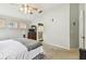 Serene bedroom with carpet floors, ceiling fan, and convenient access to the ensuite bathroom at 1318 Crimson Clover Ln, Wesley Chapel, FL 33543