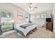 Bright bedroom with ceiling fan, neutral walls, and multiple windows for natural light at 1318 Crimson Clover Ln, Wesley Chapel, FL 33543