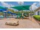 Fun-filled community playground with a large sunshade covering slides and play equipment at 1318 Crimson Clover Ln, Wesley Chapel, FL 33543