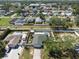 Aerial view showcasing the property's backyard, pool, and proximity to neighboring houses and street at 1601 14Th W St, Palmetto, FL 34221