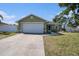 Inviting one-story home with an attached garage, complemented by a green lawn and tasteful landscaping at 1601 14Th W St, Palmetto, FL 34221