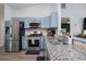 Modern kitchen featuring stainless steel appliances, granite countertops, and stylish cabinetry at 1601 14Th W St, Palmetto, FL 34221